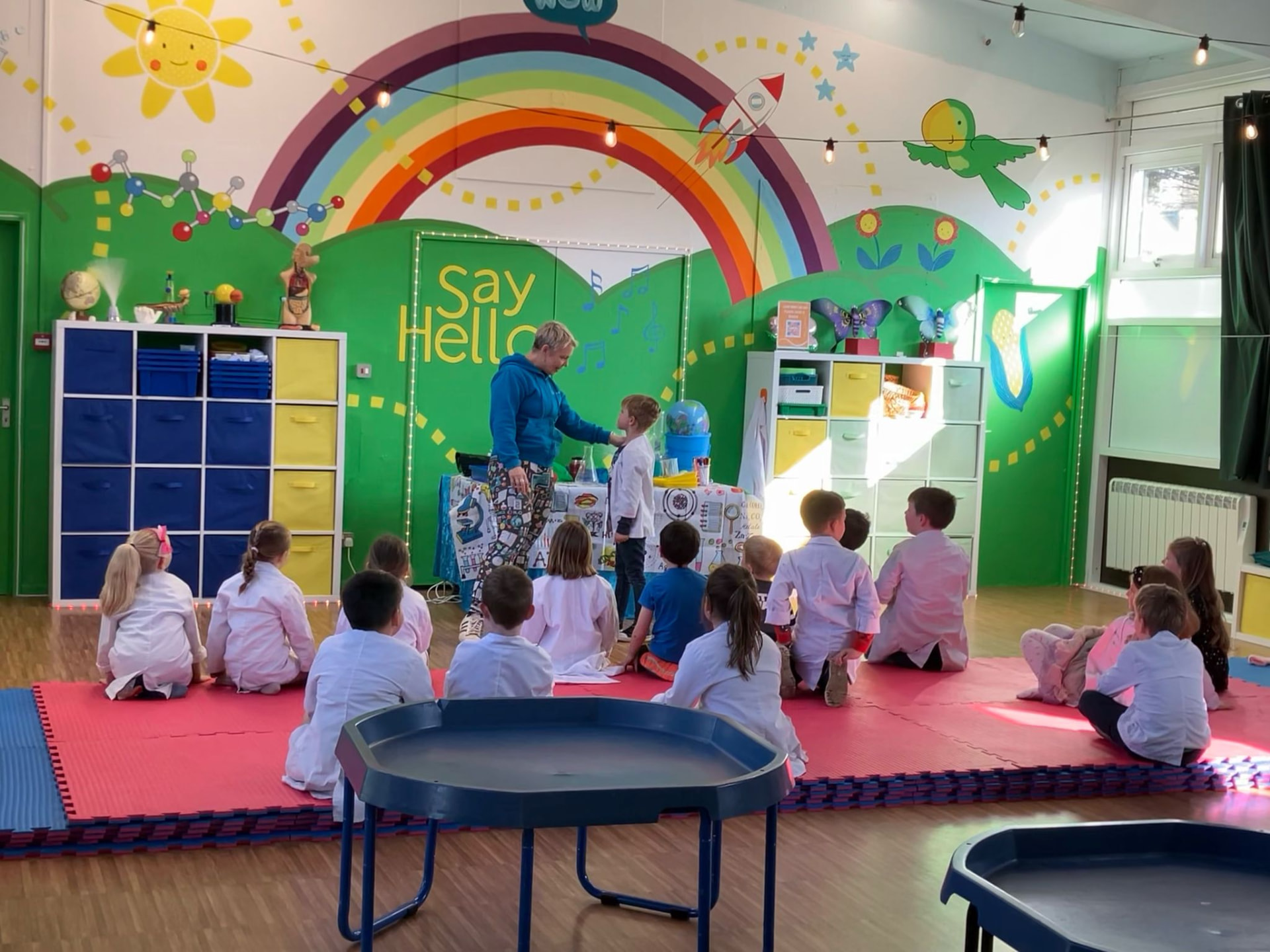 Professor Lee leading a science show for children in lab coats at WOW @ Sparks